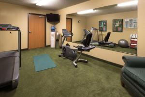 a gym with treadmills and exercise equipment in a room at AmericInn by Wyndham Minocqua in Minocqua