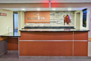 a restaurant with a cow on the top of a counter at AmericInn by Wyndham Grand Forks in Grand Forks