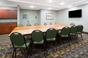 a conference room with a large wooden table and chairs at AmericInn by Wyndham Sibley in Sibley