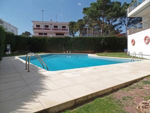 a swimming pool with a slide in a yard at Appartement Les Gavines in L'Escala