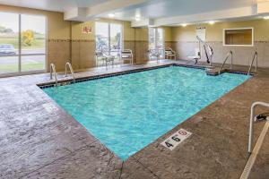 a large pool with blue water in a hotel room at AmericInn & Suites Burnsville, MN in Burnsville