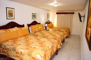 Postel nebo postele na pokoji v ubytování Hotel Los Jardines