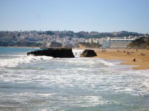 a view of a beach with people in the water at Albufeira Beach Hotel by Kavia in Albufeira