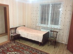 キスロヴォツクにあるДомのベッドルーム1室(ベッド1台、椅子2脚、窓付)