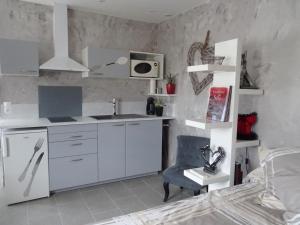 a kitchen with a sink and a desk in a room at rêverie in Balaruc-les-Bains