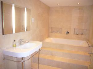 a bathroom with a sink and a bath tub at Warborough B&B in Wallingford