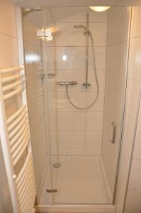 a shower with a glass door in a bathroom at Haus Renate in Kartitsch