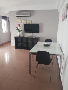 a dining room with a table and two chairs at Sun and Beach Spain 1B in Nerja