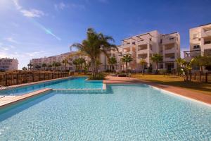 a large swimming pool in front of a building at Terrazas de la torre 432 in Roldán