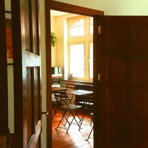 a room with a table and chairs and a window at De Mot B&B in Brussels