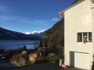 a house with a view of a lake and mountains at Lakeviewhouse in Sundlauenen