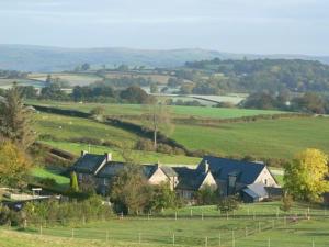 a group of houses in a green field at The Draen Bed and Breakfast in Brecon