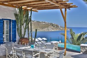 a table on a patio with a view of the ocean at Villa Athena by Elite Estates in Agios Ioannis Mykonos