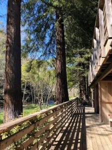 a wooden fence with trees in the background at Big Sur River Inn in Big Sur