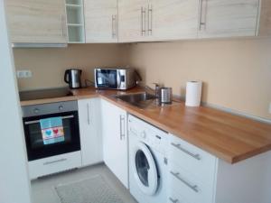 a kitchen with a sink and a washing machine at Appartamento Erika in Gran Tarajal