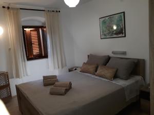 Ένα ή περισσότερα κρεβάτια σε δωμάτιο στο Paradise apartment - Old town Rab