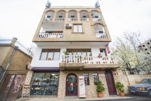 a building with a balcony on top of it at Midtown-Vera in Tbilisi City