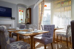 a dining room with a table and chairs at The Beechcliffe Hotel - Over 35's Only in Blackpool