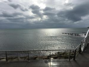 a view of the ocean under a cloudy sky at B2 Waterfoot Apartment in Newcastle