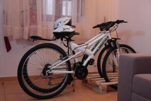 a bike parked in a room with a helmet on it at Casa das Andorinhas in Faro