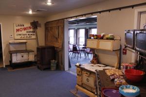 a room with some old appliances and a dining room at The BarnwooD Inn in Humansville