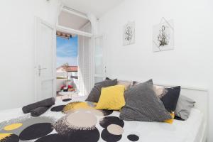 a room with a couch with pillows on it at Apartman Roko in Petrcane