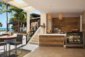 a kitchen and dining area of a house with the beach at Zoetry Montego Bay in Montego Bay