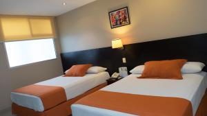Postel nebo postele na pokoji v ubytování Hotel Los Almendros