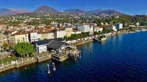 a city with a dock in the middle of the water at La Basilica in Verbania