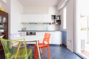 a kitchen with a table and colorful chairs at Downtown apt quiet with terrace and lift in Florence