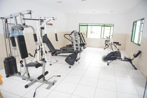 a gym with several tread machines in a room at Plaza Dutra Hotel in Caçapava