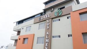 a hotel sign on the side of a building at Hotel Los Almendros in Manta