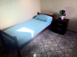 a small bedroom with a bed and a nightstand with a bed sidx sidx sidx at Casa Temporada em Cavalcante in Cavalcante