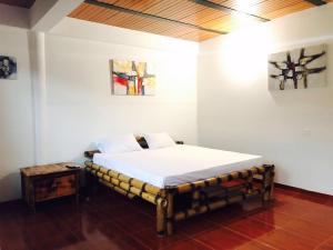 a bedroom with a bed and a table in it at Hotel Campestre VillaMaria in Vergara +233 photos