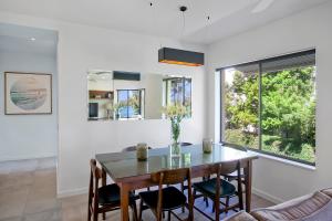 a dining room with a table and chairs at Aarons Luxury Retreat in Noosaville
