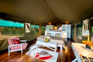 a bedroom in a tent with a bed and a table at Flameback Eco Lodge in Tissamaharama