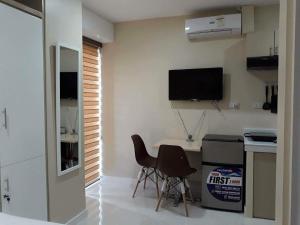 a kitchen with a desk and two chairs in a room at YulZ 516 at Cityscape in Bacolod