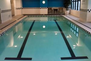 a large swimming pool with blue water at Auckland Centre Studio w/ Pool and Gym in Auckland