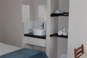 ein Badezimmer mit Waschbecken und Bett in der Unterkunft Bohemia Resort Cairns in Cairns
