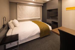 Un pat sau paturi într-o cameră la Hotel Granbinario Komatsu