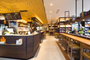 a restaurant with wooden counters and tables and chairs at Hotel Granbinario Komatsu in Komatsu