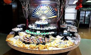 a table topped with lots of different types of cakes at FARS Hotel & Resorts - BAR-Buffet-Pool-SPA in Dhaka