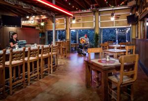 a restaurant with tables and a man playing a guitar at Hyatt Vacation Club at Wild Oak Ranch in San Antonio