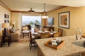 a living room with a kitchen and a dining room at Hyatt Vacation Club at Ka'anapali Beach in Lahaina