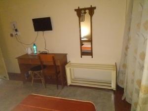 a room with a desk and a mirror at Happy Homes in Guwahati