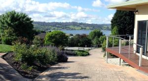 a walkway next to a house with a view of a lake at Ou+look BnB in Rosevears