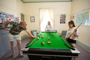 a group of people playing a game of pool at Port Fairy YHA in Port Fairy