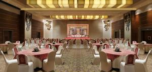 a banquet hall with tables and chairs in a room at Grand Mercure Vadodara Surya Palace in Vadodara
