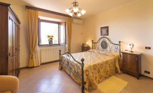 a bedroom with a bed and a window at Agriturismo Colombaiolo in Pienza +48 photos