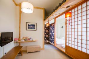 a room with tiled walls and a room with a window at Hsieh's Home in Taitung City